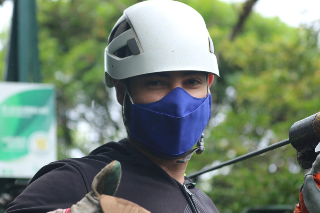 a young boy wearing a helmet ready to zipline