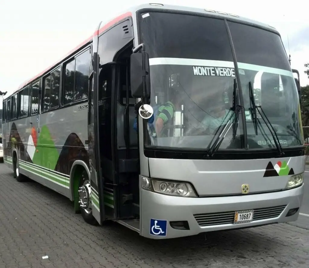 a passenger bus that is parked on the side of a road
