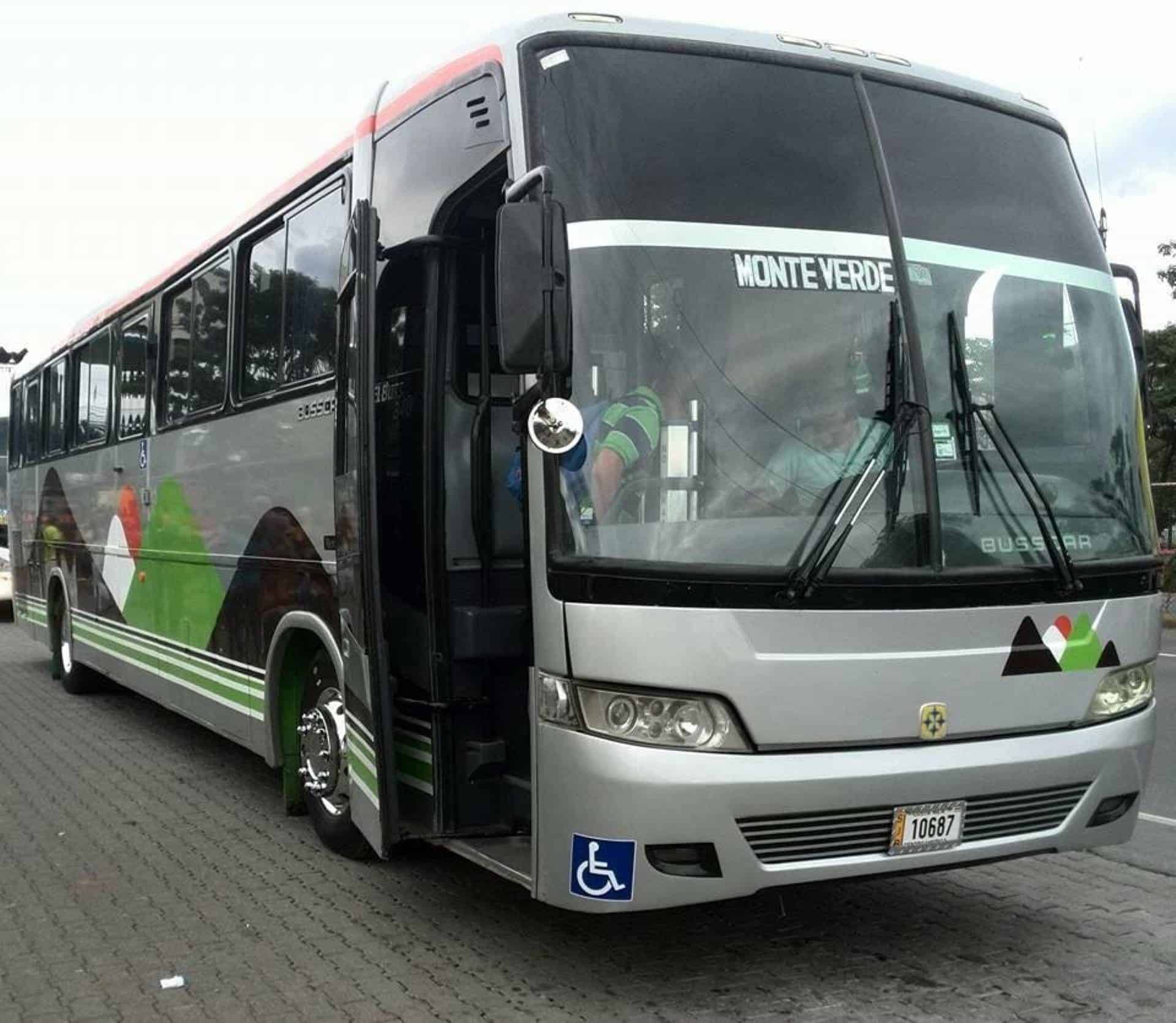 a passenger bus that is parked on the side of a road