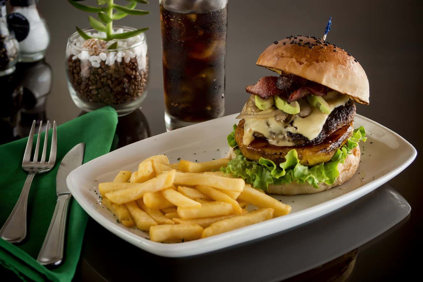 a plate of food with a sandwich and fries on a table