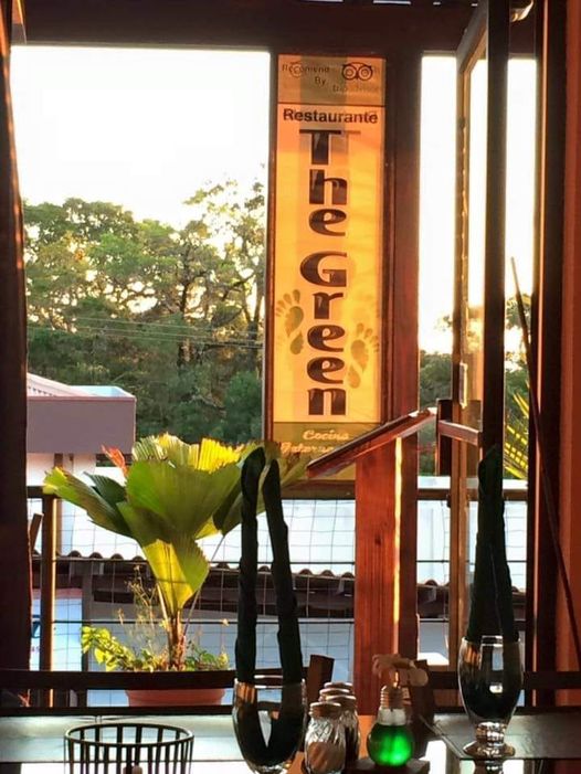 a group of people sitting at a table in front of a building