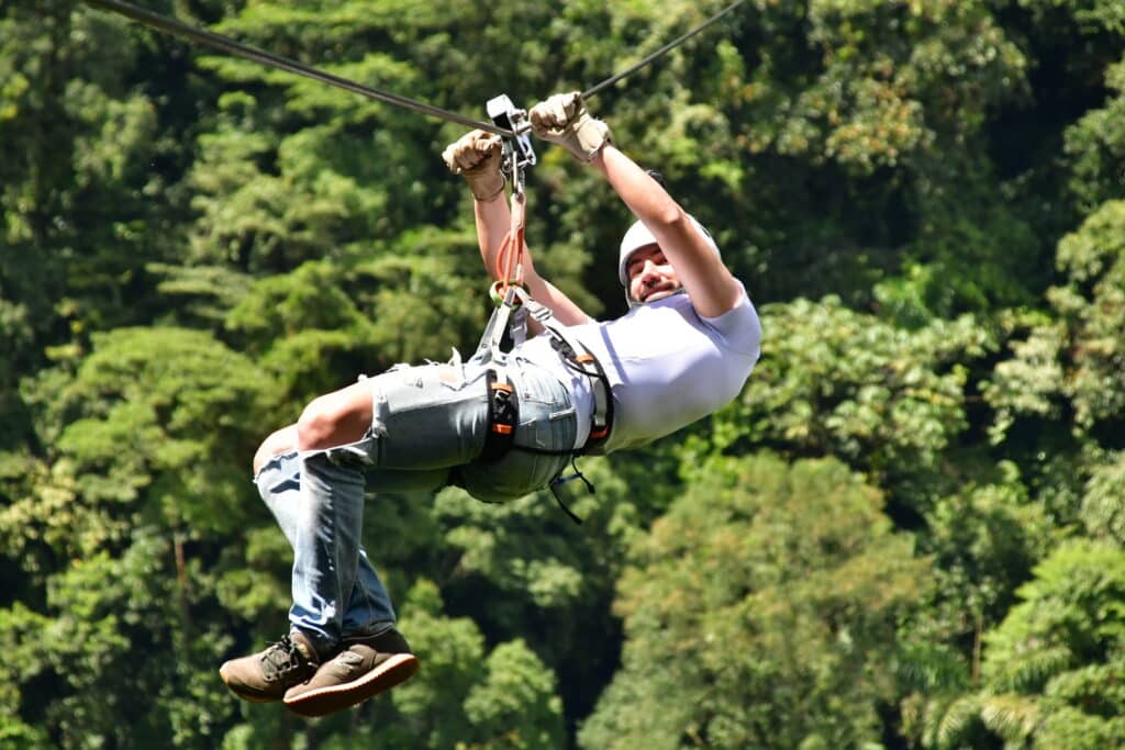 a person ziplining with white helmet