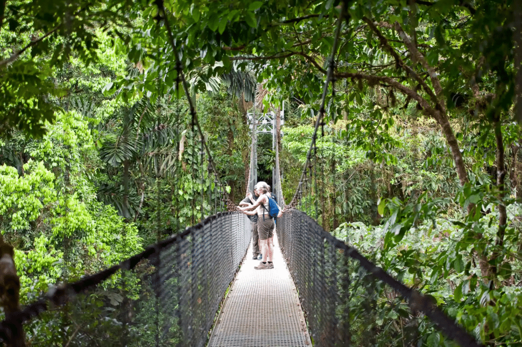 A couple walking in a hanging bridge in Arenal