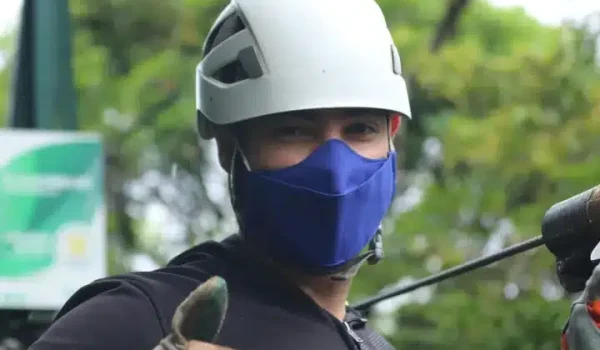 a young boy wearing a helmet ready to zipline