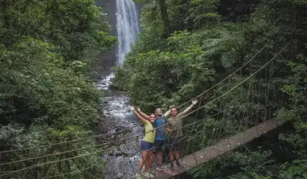 a man riding a bike down a dirt road