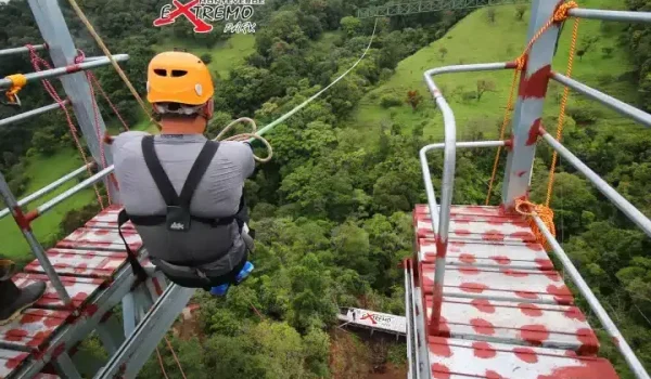 a man jumping off the Monteverde Extremo Mega Swing Platform
