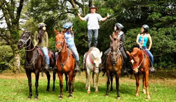 a group of people riding on the back of a horse at Horse Trek Horseback Riding Tour