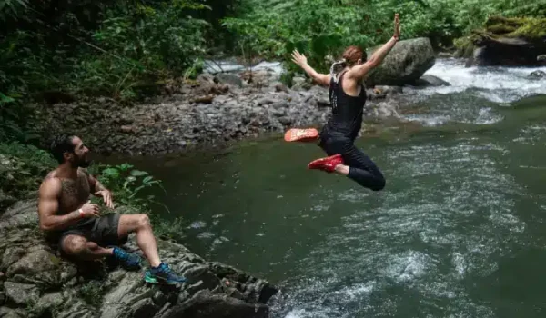 a group of people swimming in a body of water on a Monteverde Waterfall Tour