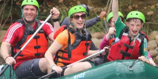 a group of people riding on a raft in the water