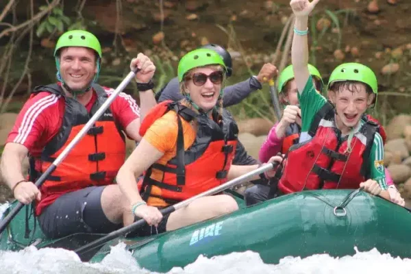 a group of people riding on a raft in the water